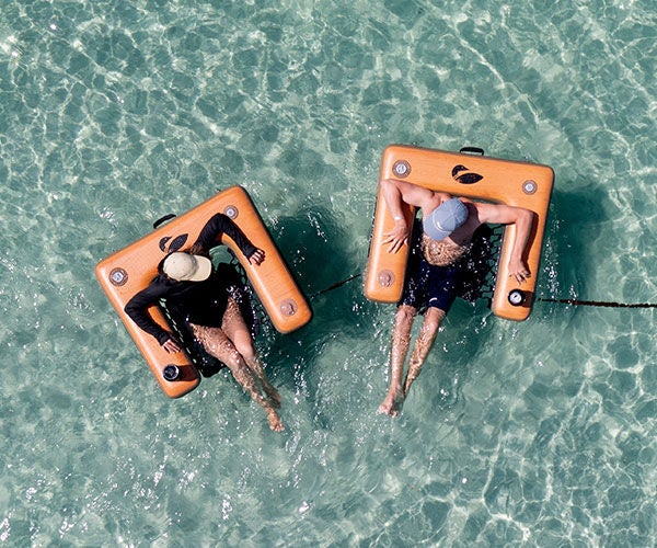 Inflatable Chairs on blue shallow water