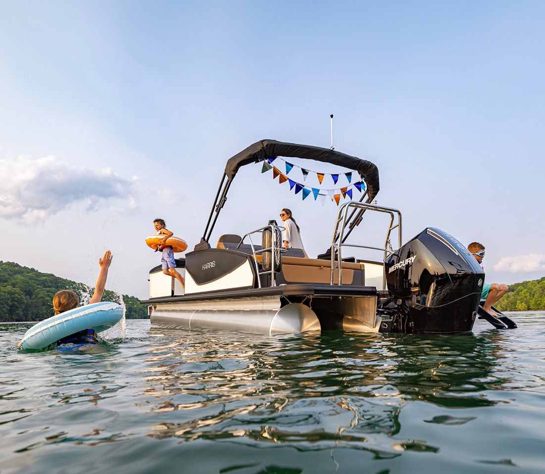 Kid Jumping off the side of a Harris Pontoon