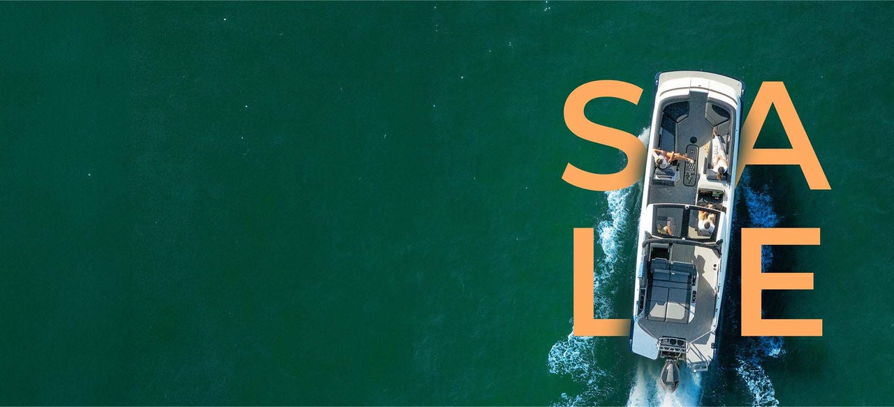 A Harris Pontoon on the water with the word SALE surrounding it