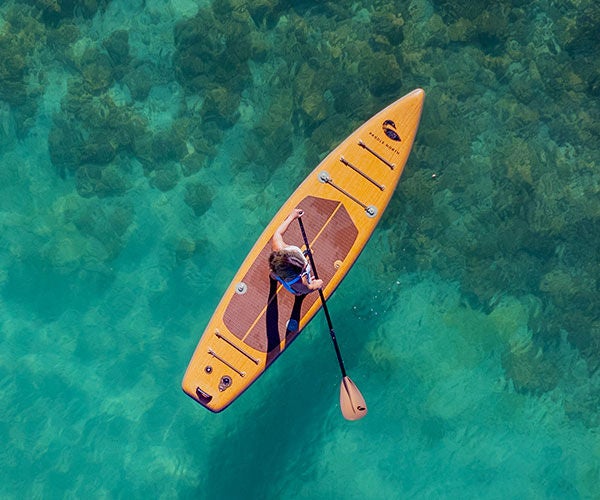 Orange paddle board over clear blue water