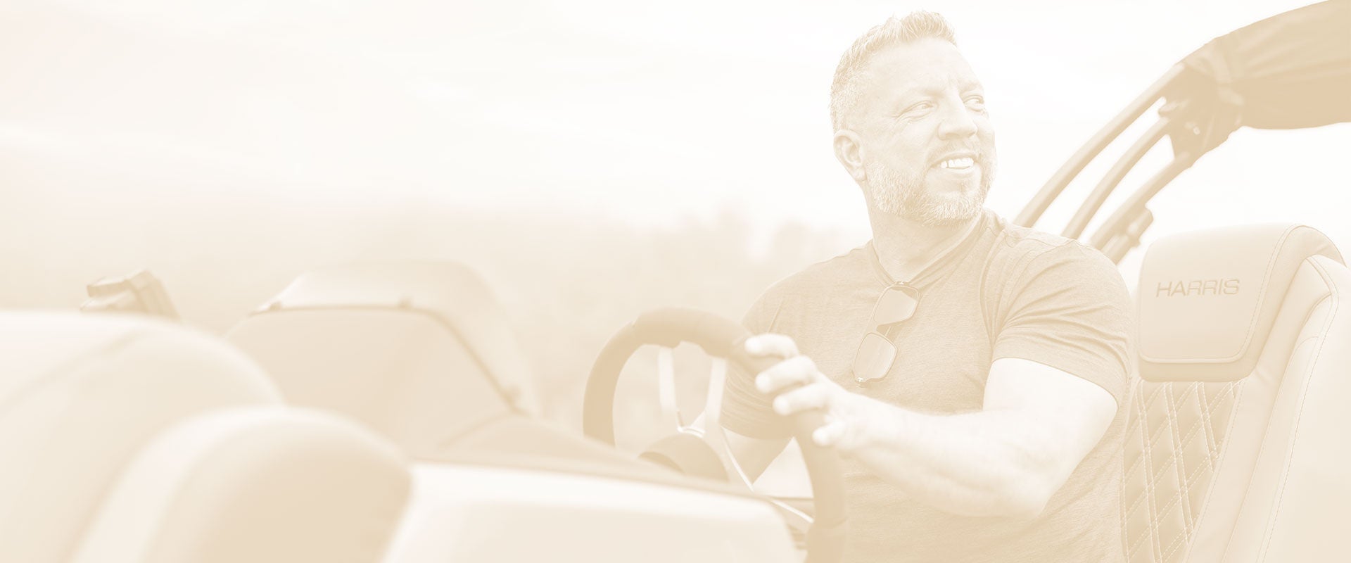 Sepia toned image of a man driving his boat